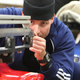 A bobsled engineer inspects one of the four runners.
